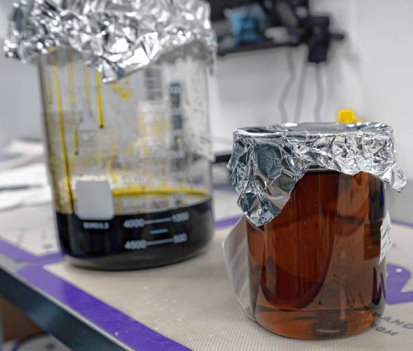 The jar on the left is a oil extracted from the cannabis plant that is then refined further to make distillate, the jar on the right, which is used in the infused products at Wemelco in Easthampton.