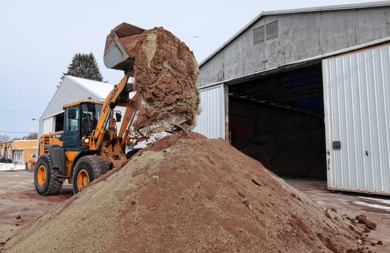 Josh Miller, an employee of the  Belchertown DPW, mixes sand and salt in preparation for upcoming snow and ice storms on Feb. 12. 