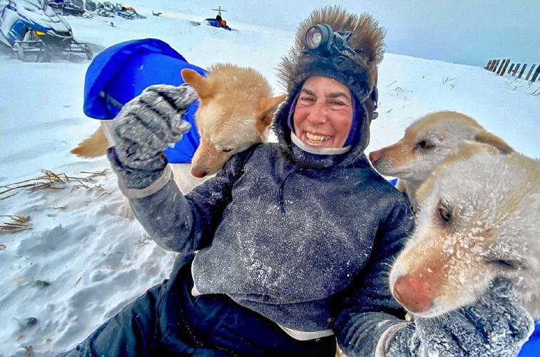 A gal and her dogs: Marla Brodsky, known as Marla BB, poses in Alaska’s frozen wastes with some of the dogs that pulled her on a 750-mile run on a historic trail in the state. 