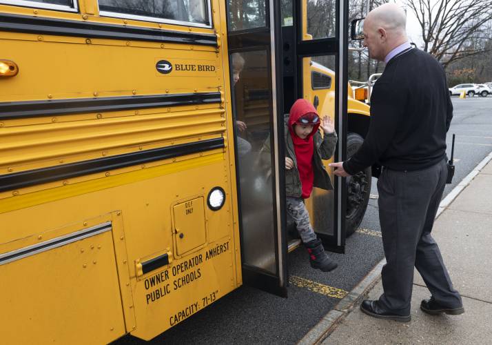 Crocker Farm Elementary School Principal Derek Shea gets a high five from Jessie St. Marie as he gets off the bus Wednesday morning. Shea greets each child as they head into the Amherst school every morning. “How was your birthday party? Let’s see those eyes. Want to hold my hand?” are some of the questions he asked last week as he helped with backpacks or stopped to look at a drawing. “It’s a friendly face to start the day,” said Shea. 
