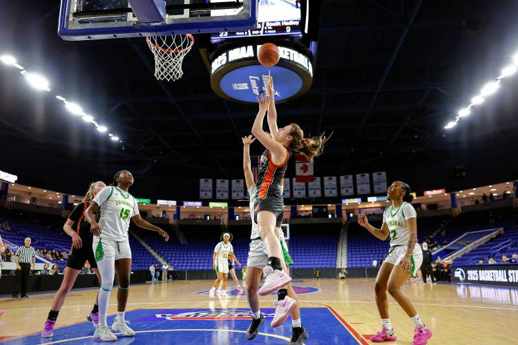 South Hadley’s Olivia Athas (5) goes up for a layup against Cathedral in the second quarter of the MIAA Div. 4 state championship Sunday at the Tsongas Center in Lowell. 