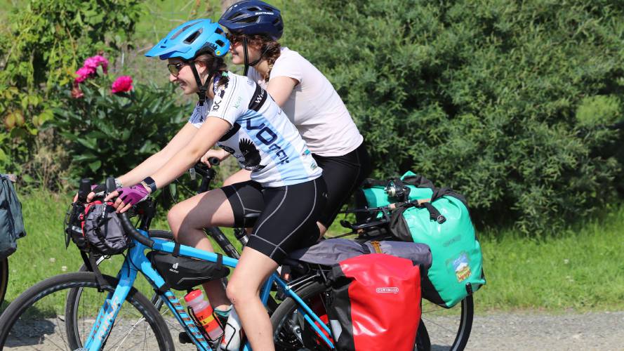  Molly Rowlett, front, and Ursa Rossman, juniors at Northampton High School, depart for a bike trip that will take them 120 miles across western Massachusetts. 