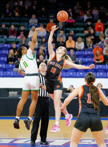South Hadley’s Ava Asselin (10) jumps for the tip-off against Cathedral’s Tamia Darling (11) in the first quarter of the MIAA Div. 4 state championship Sunday at the Tsongas Center in Lowell. 