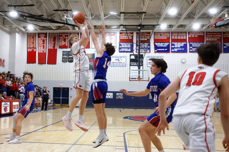 Frontier’s Garret Dredge (11) puts up a jumper over Drury defender Brayden Durant (14) in the second quarter Friday night at Goodnow Gymnasium in South Deerfield.