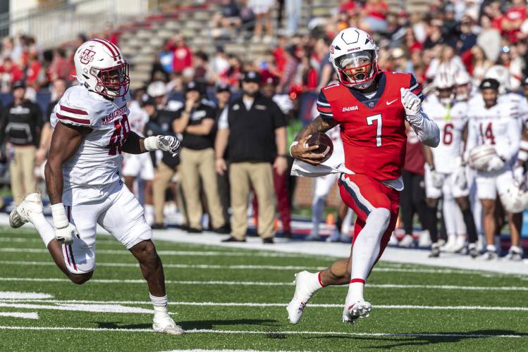Liberty's Kaidon Salter, right, runs the ball for a touchdown past UMass' Jerry Roberts Jr. during the first half on Saturday  in Lynchburg, Va.