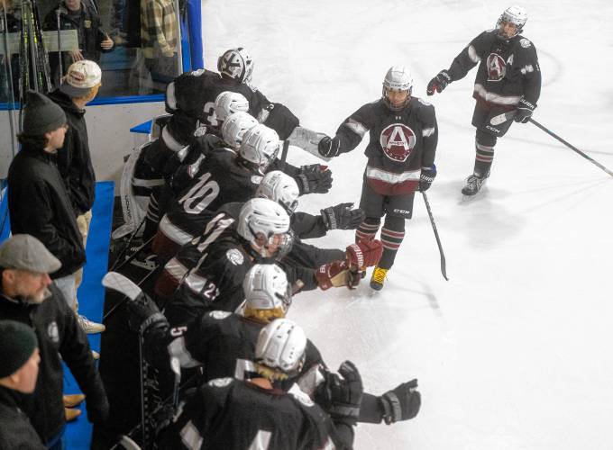 Amherst forward Eric Chen, center, celebrates with his teammates after scoring a goal during the high school hockey game against Easthampton at Lossone Rink, Friday, Feb. 7, 2025, in Easthampton.