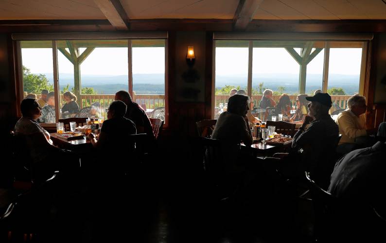 Diners enjoy scenic views from both indoors and on the deck at Tavern On The Hill in Easthampton.