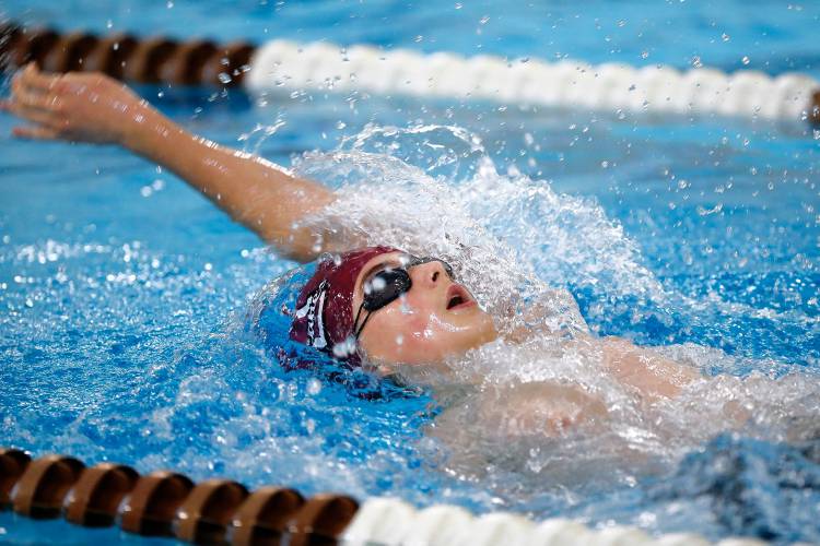 Amherst’s Lewin Halasz competes in the 100 yard backstroke against Monson on Friday in Amherst.