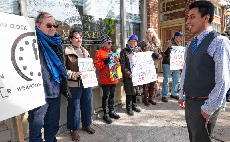 Koby Gardner-Levine, regional manager for U.S. Rep James McGovern’s office, talks to members of Massachusetts Peace Action in front of McGovern’s Northampton office. The Monday rally, which coincided with the third anniversary of Russia’s invasion of Ukraine, was called to support peace negotiations  in the war. 